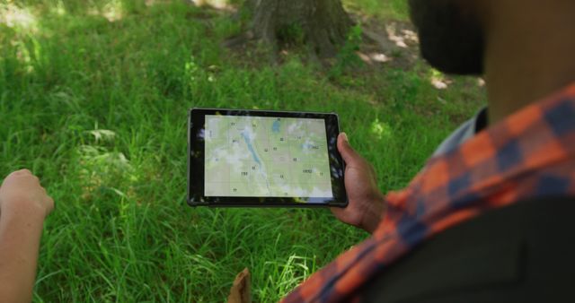 Man using digital tablet for navigation during outdoor adventure - Download Free Stock Images Pikwizard.com