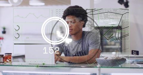 Barista interacting with augmented reality interface over glass counter in modern cafe