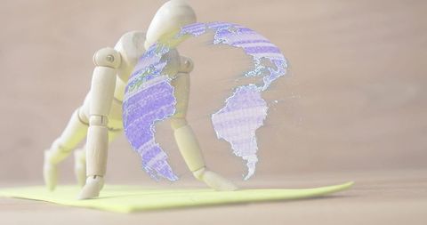 Wooden mannequin reaching toward holographic globe on minimalist desk with yellow accent