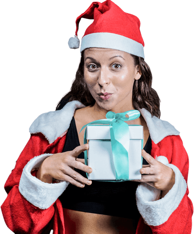 Cheerful athlete holding gift wearing santa hat transparent background