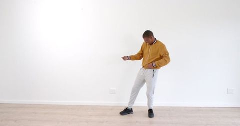Young Man Dancing Energetically in Modern Minimalist Living Room