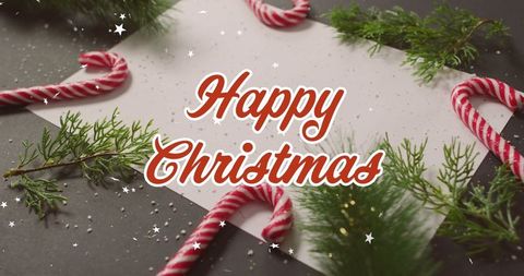 Festive christmas flat lay with candy canes and evergreen