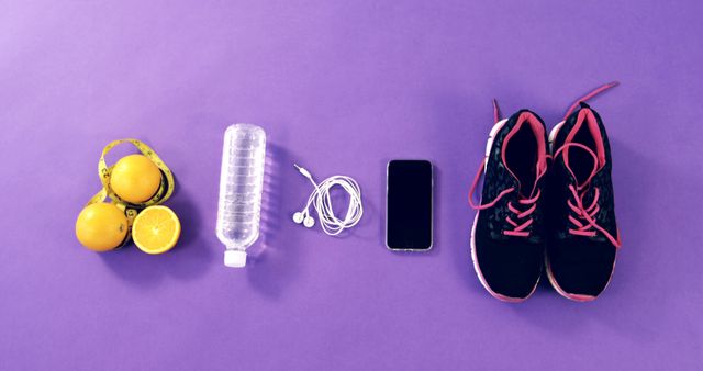 Mobile phone with headphones, shoes, water bottle, lemon and measuring tape on table 4k