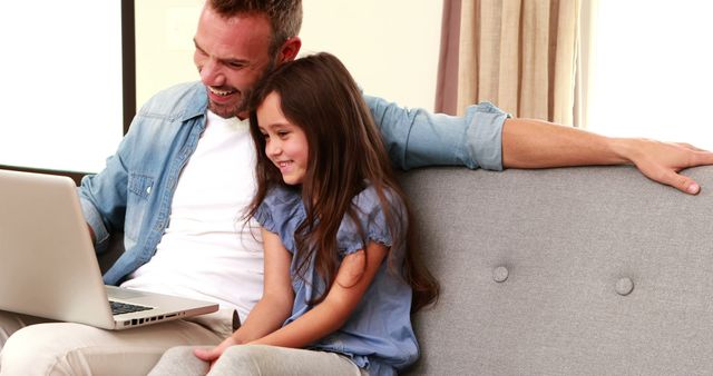 Father and Daughter Bonding Using Laptop on Sofa - Download Free Stock Images Pikwizard.com