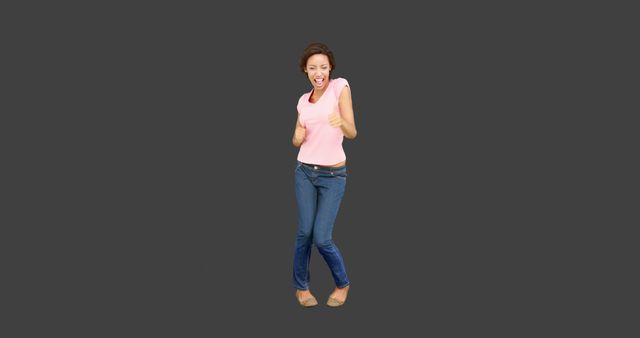 Excited Woman in Pink Top and Jeans Giving Thumbs Up - Download Free Stock Images Pikwizard.com