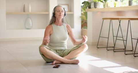 Serene Mature Woman Meditating with Headphones