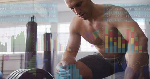 Muscular Man Preparing for Barbell Lift with Data Visuals in Gym
