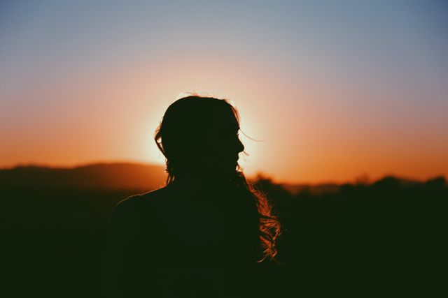 Silhouette of Woman at Sunset with Golden Light - Download Free Stock Photos Pikwizard.com