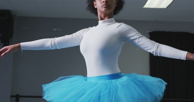 Ballerina in blue tutu practicing pirouette in dance studio - Download Free Stock Images Pikwizard.com