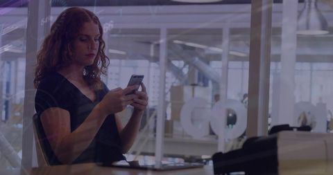 Woman Using Smartphone in Open-Plan Office