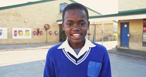 Young African Student Smiling in School Uniform in Playground