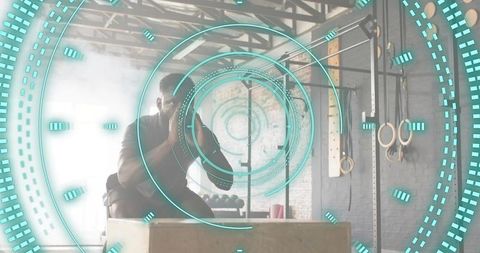 Athlete performing explosive box jump in industrial gym with teal hud fitness overlay