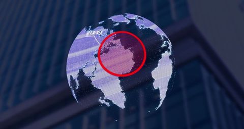 Digital globe overlay on urban building, representing global business