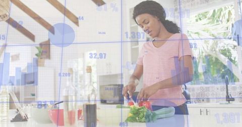 Woman preparing healthy meal in modern kitchen with tablet and digital data overlay