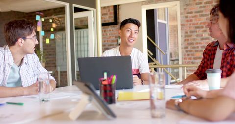 Team collaboration: diverse colleagues engaging in office discussion