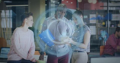 Team collaborating on tablet with augmented reality data visualization in office workspace