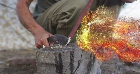 Woodworking artisan crafting with fiery effects outdoors
