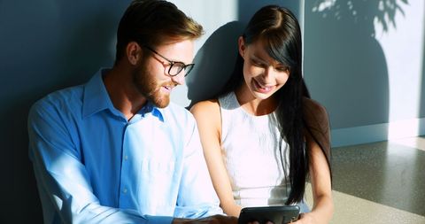 Young Professionals Enjoying Tablet Collaboration