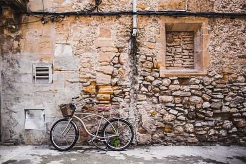 Vintage bicycle against rustic stone wall