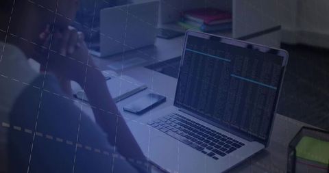 Developer rubbing temples while viewing terminal on laptop in dim office