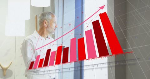 Businessman analysing financial growth overlaid with data graph