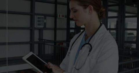 Confident Doctor Using Tablet in Modern Hospital Environment