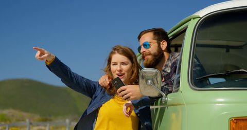 Couple Road Tripping in Classic Van Enjoying Scenic View