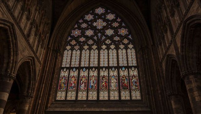 Graceful gothic stained glass illuminating historic cathedral interior