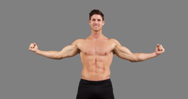 Muscular Man Flexing Muscles Against Gray Background - Download Free Stock Images Pikwizard.com