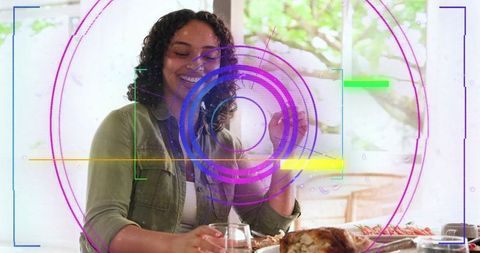 Smiling woman showcasing roasted turkey with colorful ar hud overlay at sunny window table
