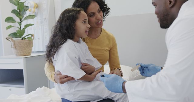 Caring Doctor with Young Patient and Mother in Hospital Room - Download Free Stock Images Pikwizard.com