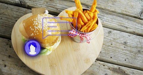 Serving sesame burger and fries on heart-shaped bamboo board with purple digital overlay