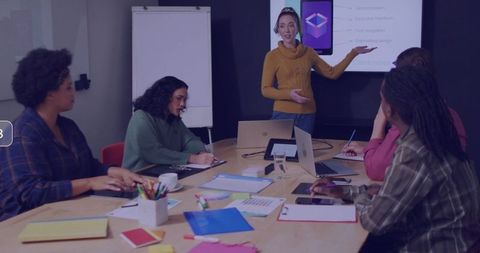 Woman Giving Presentation on Smartphone App Design in Modern Office