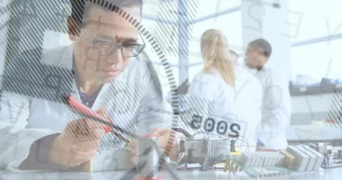 Male scientist conducting circuit analysis in research lab