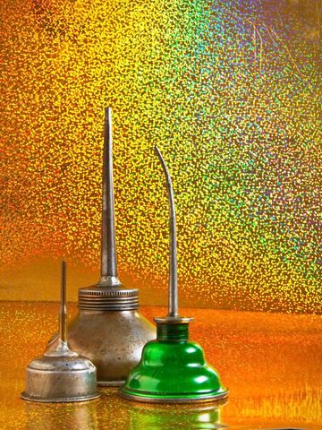 Vintage Oil Cans Against Vibrant Backdrop