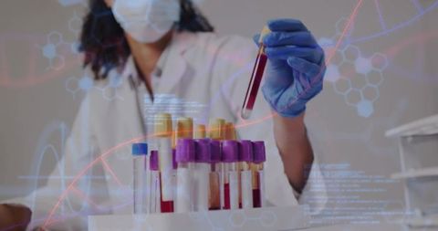 Laboratory technician holding blood vacutainer with dna overlay for clinical diagnostics
