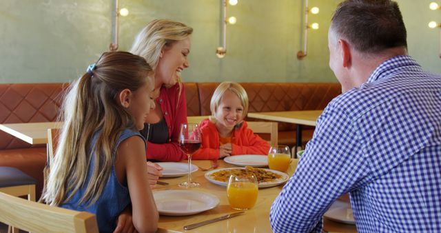 Family Enjoying Meal Together in Cozy Restaurant Setting - Download Free Stock Images Pikwizard.com