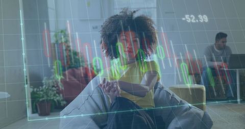 Businesswoman Analyzing Data with Digital Financial Graphs Overlay