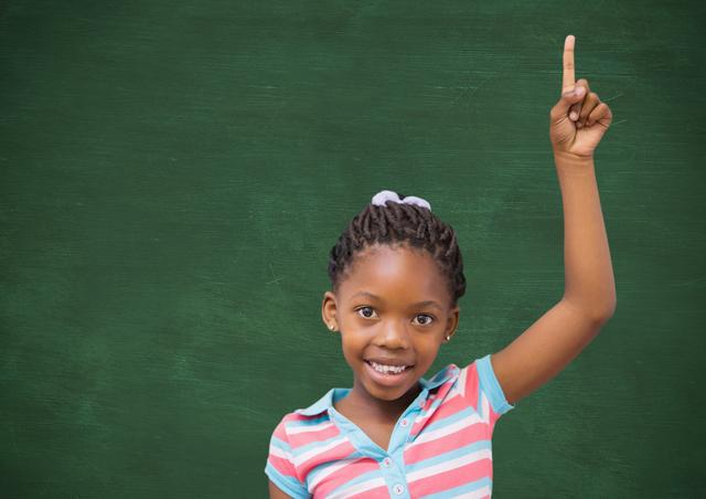 Portrait of a school girl raising finger in classroom - Download Free Stock Photos Pikwizard.com