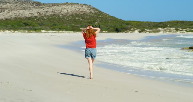 Woman Walking Alone on Secluded Beach with Hills in Background - Download Free Stock Images Pikwizard.com