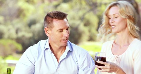Middle-Aged Couple Enjoying Wine Outdoor in Relaxed Setting - Download Free Stock Images Pikwizard.com