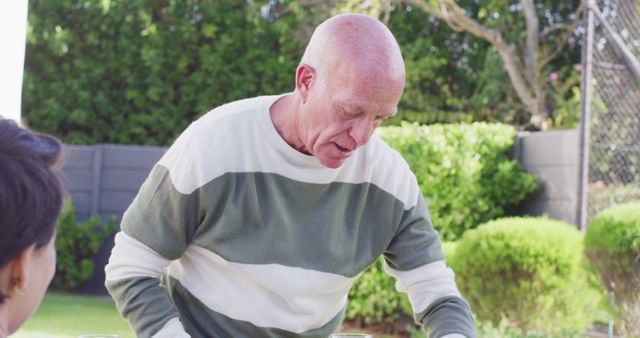 Senior Man Enjoying Outdoor Meal in Sunny Garden - Download Free Stock Images Pikwizard.com