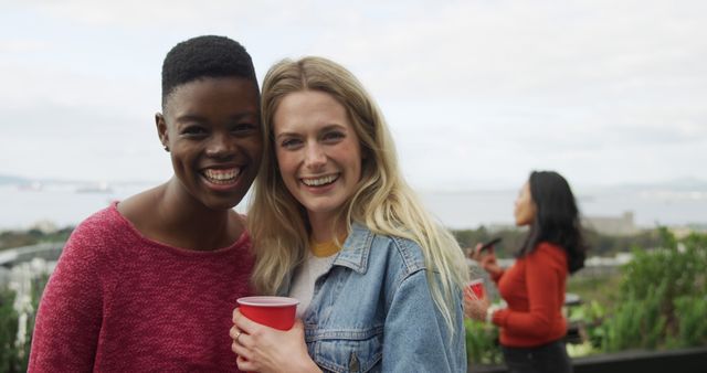 Smiling Friends at Outdoor Gathering with Red Cups - Download Free Stock Images Pikwizard.com