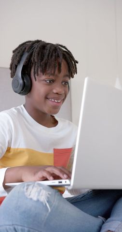 Cheerful Young Boy in Headphones Using Laptop at Home - Download Free Stock Images Pikwizard.com