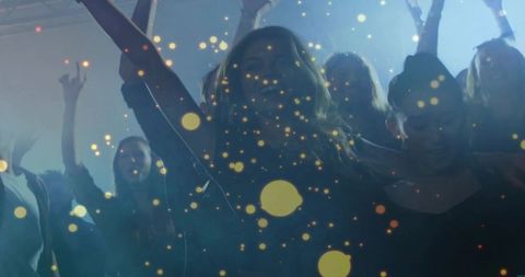 Nightclub crowd dancing with golden bokeh lights and blue haze backlighting energy