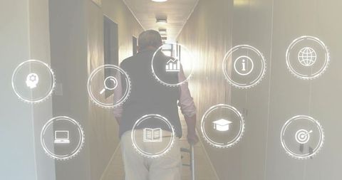 Senior man walking with cane in bright corridor wearing vest mobility and healthcare icons