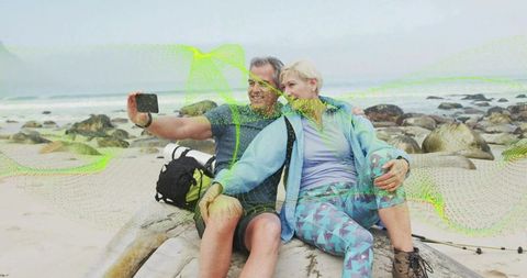Posing Couple Hiking and Capturing Beach Selfie with Smartphone