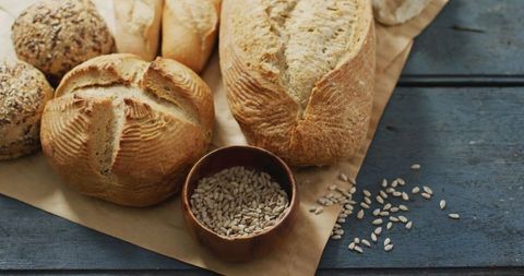 Assorted artisan breads on rustic wooden surface
