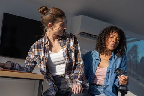 Diverse Businesswomen Discussing Digital Payment in Office