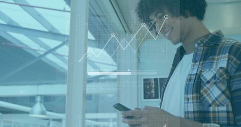 Young professional checking mobile analytics with augmented reality overlay in modern office